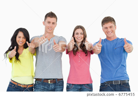 Four friends giving the camera the thumbs up Four friends giving the camera the thumbs up 6775455