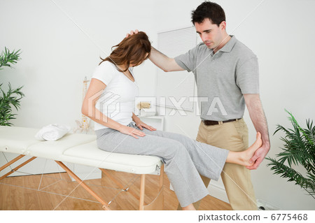 Physiotherapist manipulating his patient while standing 6775468