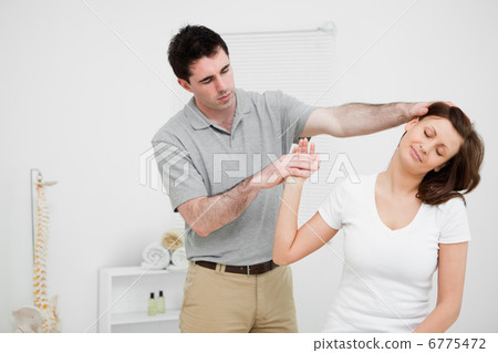 Woman being examined her neck by a doctor Woman being examined her neck by a doctor 6775472