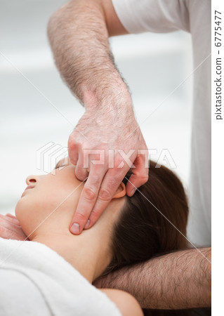 Therapist pressing with two fingers on the neck of his patient Therapist pressing with two fingers on the neck of his patient 6775477