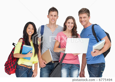 A smiling group of students holding a laptop while looking at th 6775494