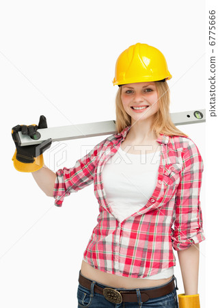 Cheerful woman holding a spirit level 6775666