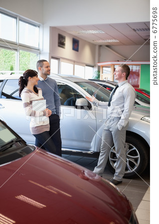 Salesman talking with a couple Salesman talking with a couple 6775698
