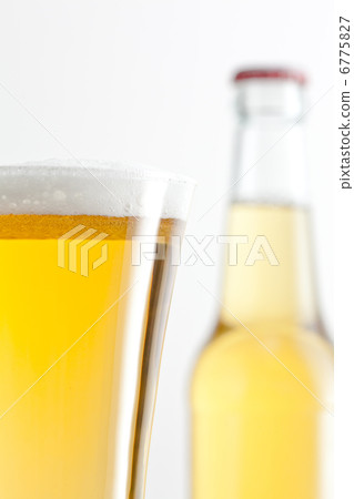 Glass and bottle of beer against a white background Glass and bottle of beer against a white background 6775827