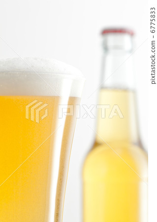 Bottle and glass of beer against a white background Bottle and glass of beer against a white background 6775833