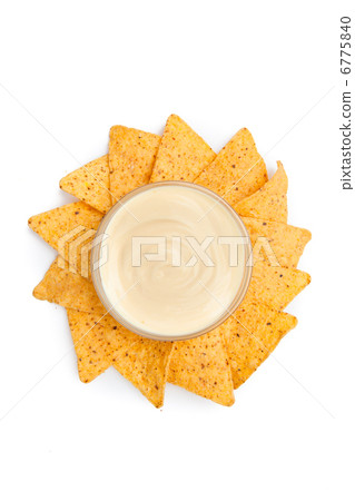 Nachos placed around a bowl of white dip Nachos placed around a bowl of white dip 6775840