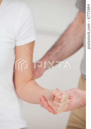 Close up of a a man stretching an elbow Close up of a a man stretching an elbow 6775864