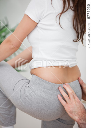 Woman standing while a man massaging her back Woman standing while a man massaging her back 6775930