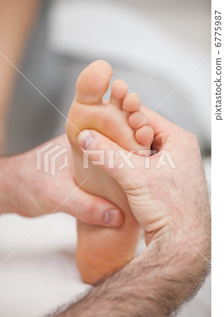 Sole of foot being massaged 6775987