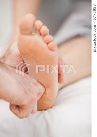 The ball of a foot being massaged 6775989