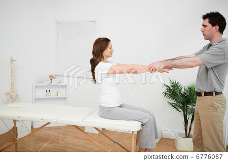 Manual stretching being made by a doctor Manual stretching being made by a doctor 6776087