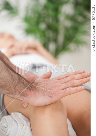 Osteopath using his hand palm to massage a knee Osteopath using his hand palm to massage a knee 6776123