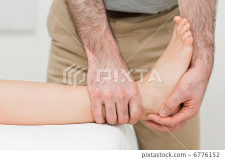 Ankle of a patient being manipulated Ankle of a patient being manipulated 6776152