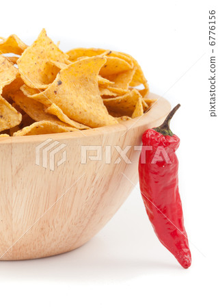 Pimento posed against a bowl full of crisps Pimento posed against a bowl full of crisps 6776156