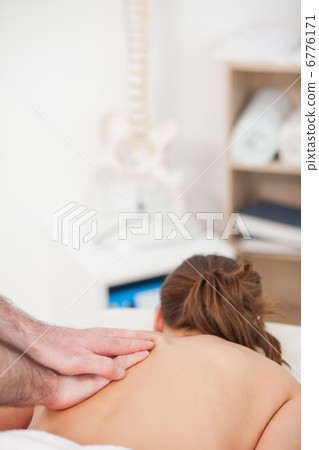 Back of the woman being massaged by a masseur Back of the woman being massaged by a masseur 6776171