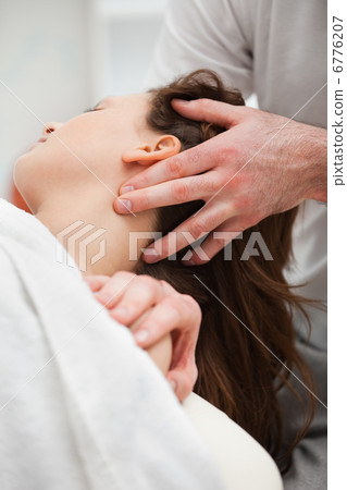 Close-up of chiropractor manipulating the neck of his patient Close-up of chiropractor manipulating the neck of his patient 6776207