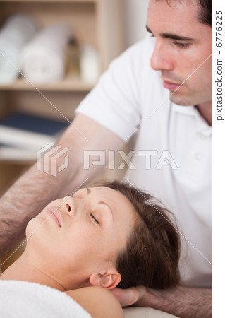 Serious doctor manipulating his patient 6776225