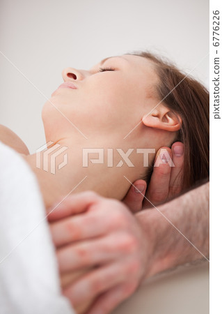 Close-up of neck of woman beig manipulating by a therapist Close-up of neck of woman beig manipulating by a therapist 6776226