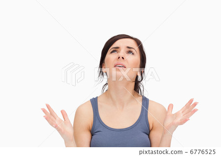 Young woman begging while looking up Young woman begging while looking up 6776525