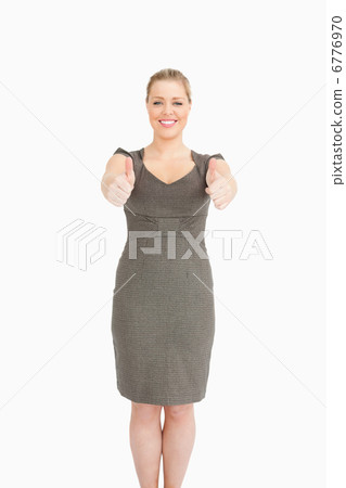 Woman standing while she is thumps up 6776970