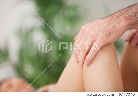 Legs being held by a practitioner Legs being held by a practitioner 6777040