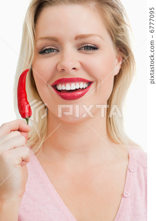 Cheerful blonde woman showing a chili Cheerful blonde woman showing a chili 6777095