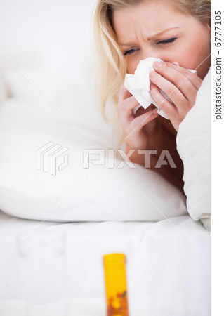 Young woman sneezing Young woman sneezing 6777105