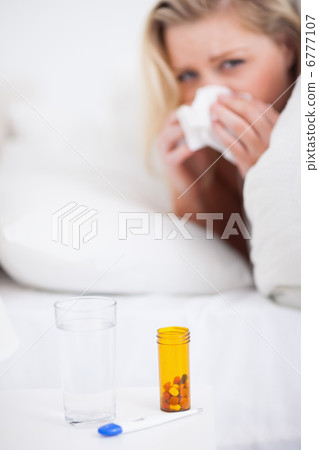 Medicines with a blonde woman sneezing Medicines with a blonde woman sneezing 6777107
