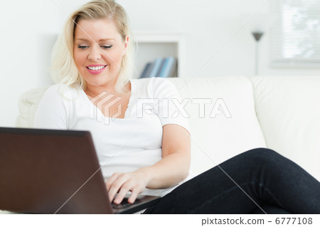 Casual woman using a laptop Casual woman using a laptop 6777108