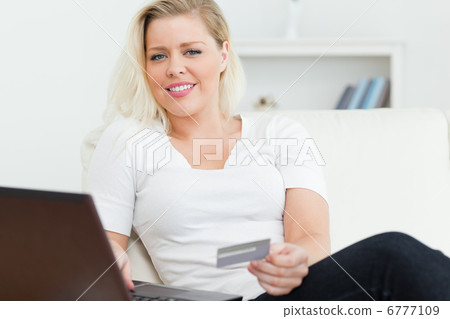 Woman with a credit card in her hand Woman with a credit card in her hand 6777109