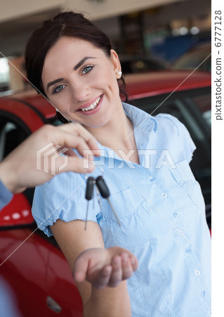 Woman smiling and receiving car keys Woman smiling and receiving car keys 6777128