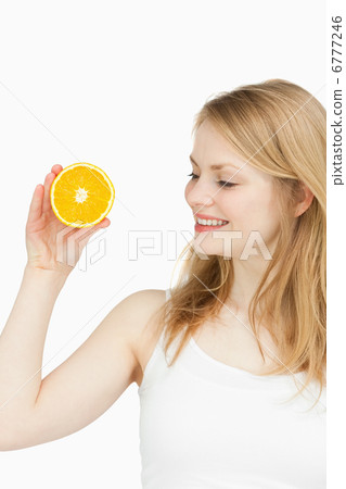 Joyful woman holding an orange Joyful woman holding an orange 6777246