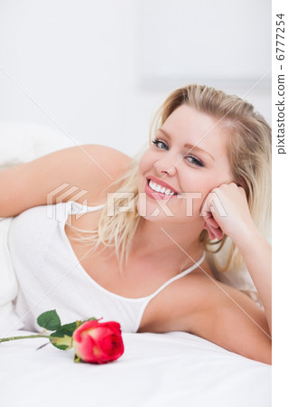 Woman with a rose smiling Woman with a rose smiling 6777254