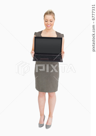 Businesswoman showing a laptop Businesswoman showing a laptop 6777331