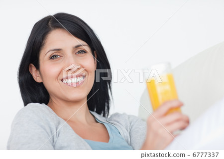 Smiling woman holding a glass of juice 6777337