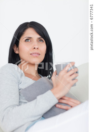 Woman holding a book and a mug Woman holding a book and a mug 6777341