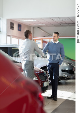 Salesman shaking hand to a customer 6777376