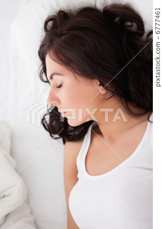 Calm woman lying on her bed while resting Calm woman lying on her bed while resting 6777461