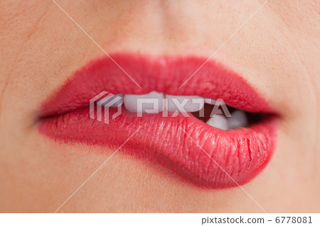 Attractive woman biting her beautiful lips Attractive woman biting her beautiful lips 6778081