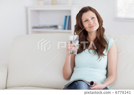 Thoughtful woman holding a glass 6778141