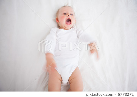 Little girl shouting while lying on a blanket 6778271