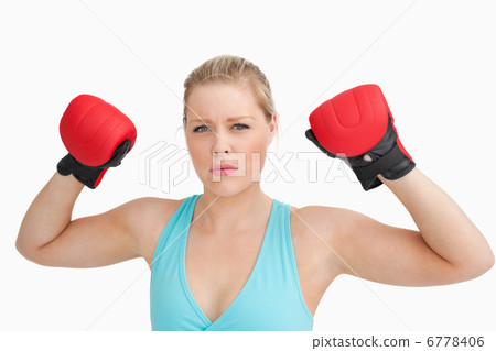 Woman showing boxing gloves Woman showing boxing gloves 6778406