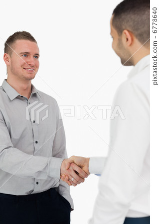 Smiling men shaking hands Smiling men shaking hands 6778640