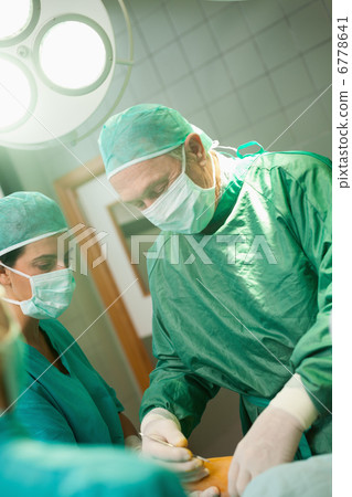Surgeon holding a scalpel Surgeon holding a scalpel 6778641