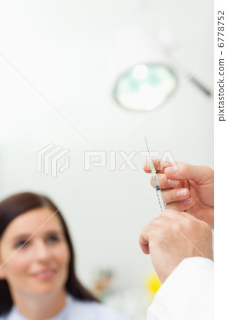 Doctor preparing an injection for a patient 6778752