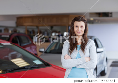 Serious brunette folding his arms 6778781