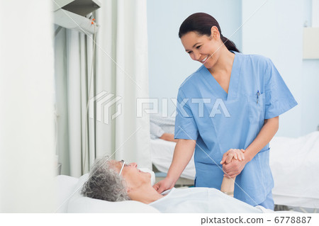 Nurse holding the hand of a patient 6778887
