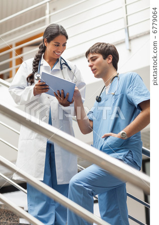 Doctor showing a tablet pc to a nurse 6779064