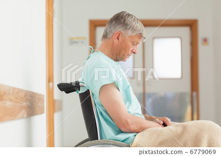 Man sitting in a wheelchair 6779069