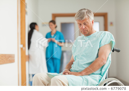 Patient in a wheelchair looking down Patient in a wheelchair looking down 6779078